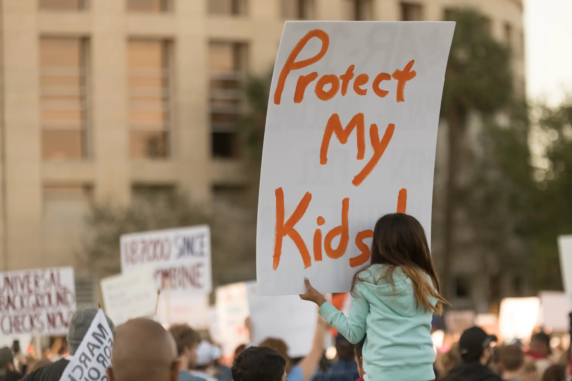 A crowd demonstrating to protect children from gun violence